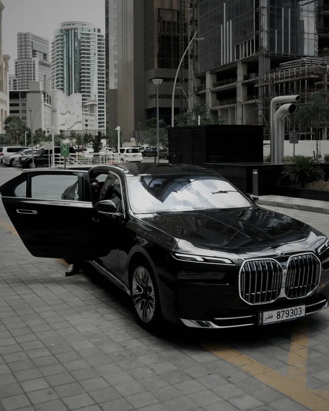 BMW i7 with its doors open at an entrance
